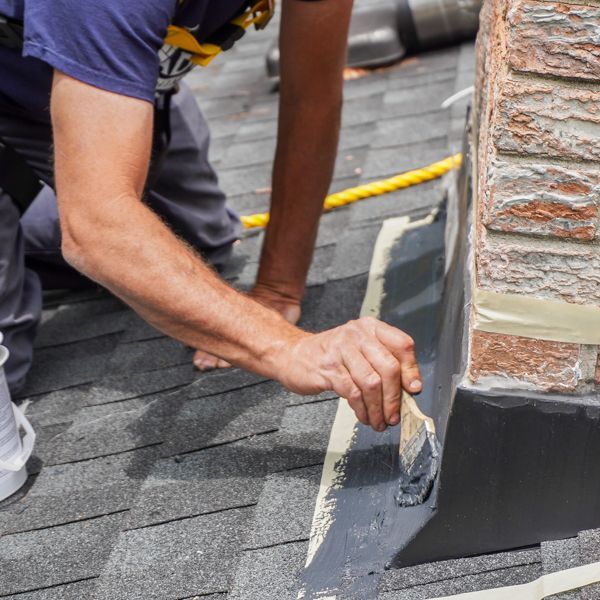 Applying elastomeric coating to chimney flashing